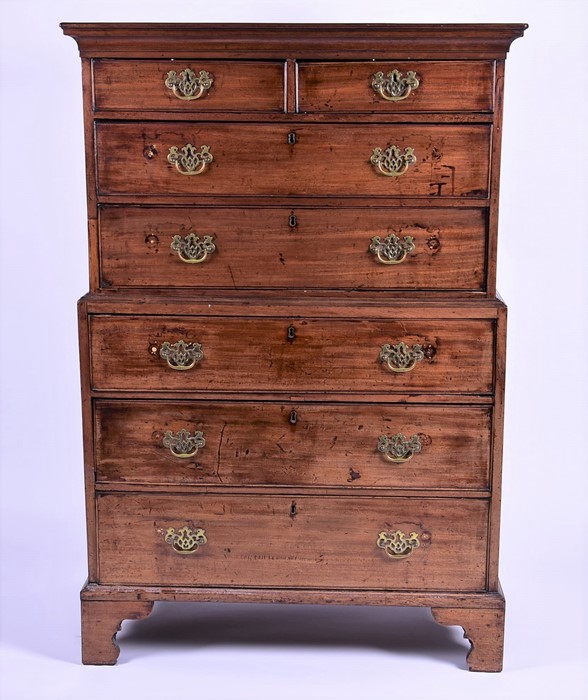 A Georgian mahogany chest on chest with moulded cornice above two short drawers on a graduated set