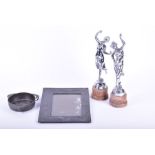 A pair of chrome figures of dancing ladies on marble plinths each 35 cm high, together with a pewter