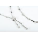 An 18ct white gold and diamond necklace set with a floral diamond cluster with two diamond-set