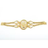 Ilias Lalalounis. An 18ct yellow gold and rock crystal bracelet centred with an oval piece of rock