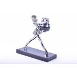 A Ronson Ballerina 'Rondelight' table lighter modelled as a chrome-plated girl carrying a ball/