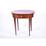 An Edwardian oval mahogany dressing table the single drawer opening to reveal a compartmentalised