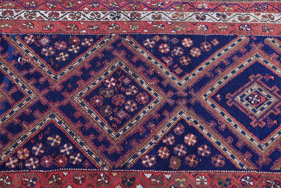 A Persian Qashqai Yalameh wool rug with triple pole medallion in an indigo field, within a triple - Image 3 of 3