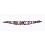 A white metal, diamond, and sapphire brooch of unusual design, the segments alternately set with