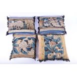 A set of four verdure tapestry upholstered and cotton velvet cushions two square, 34 cm x 29 cm, and
