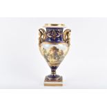 An early 19th century Derby porcelain vase of baluster form with twin figural handles, the body with