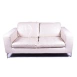 A cream leather Natuzzi two-seater sofa on four chrome feet, 172 cm x 63 cm high, the seats 66 cm