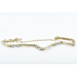 A 9ct gold, diamond, and tanzanite bracelet set with ten oval-cut pale blue tanzanites, the bracelet