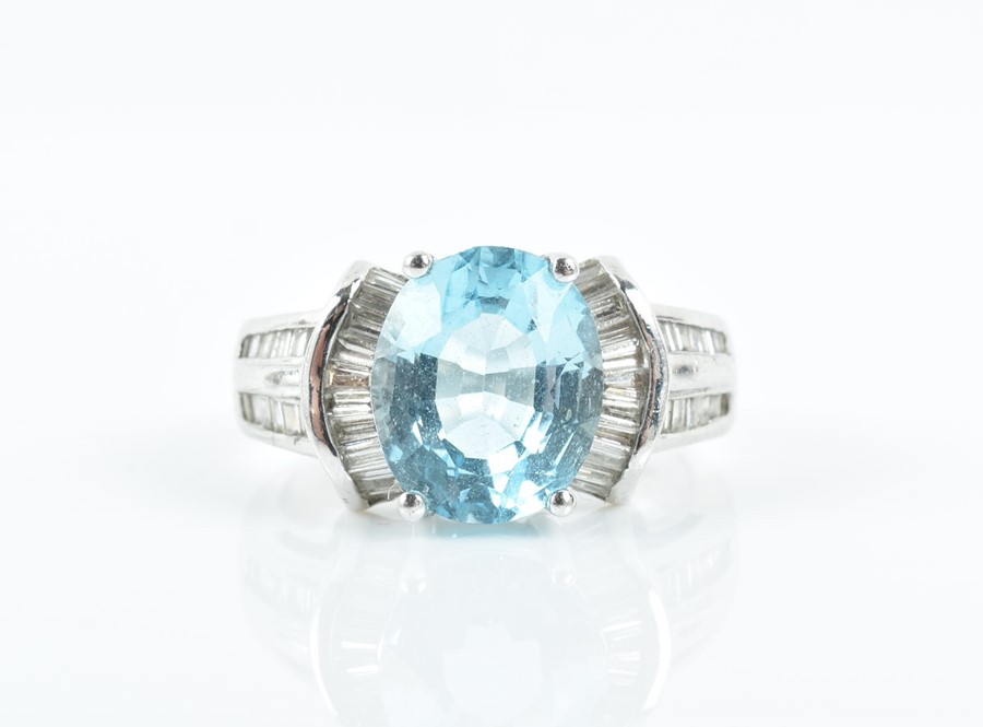 An 18ct white gold, diamond, and blue topaz ring set with an oval-cut topaz of approximately 4.0