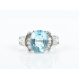 An 18ct white gold, diamond, and blue topaz ring set with an oval-cut topaz of approximately 4.0