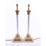A pair of 20th century table lamps with twisted glass columns on brass bases with pleated shades, 58