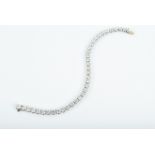 An 18ct white gold and diamond line bracelet set with thirty six round brilliant-cut diamonds, of