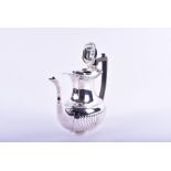 An Edwardian silver coffee pot  Chester 1906, with reeded decoration and an ebonised handle and