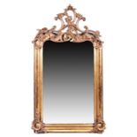 A large Rococo style gilt gesso framed wall mirror surmounted by scroll motifs, 151 cm x 79 cm (full