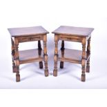 A pair of reproduction antique-style stained oak bedside tables on four turned legs each with pull