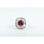 An unusual platinum, diamond, and synthetic ruby ballerina ring set with a cushion-cut red gemstone,
