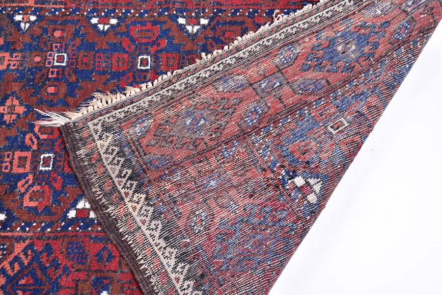 A late 19th/early 20th century Caucasian rug probably Daghestan in style, designed with madder red - Image 2 of 4