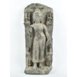 A South East Asian stone relief-carved figure of Guanyin  standing, with serene expression and right