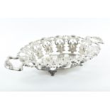 An Austro-Hungarian silver fruit basket of oval form, pierced and chased with scrolls, leaves and