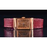 A Boucheron 18ct gold mechanical wristwatch the rectangular case with gilt dial, black markers and