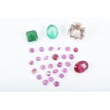 A group of various loose gemstones to include an oval-cut natural ruby, two emeralds, a cushion-