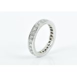 Van Cleef and Arpels. A platinum and diamond eternity ring set with round brilliant-cut diamonds