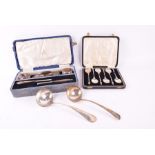 A boxed set of continental silver apostle spoons along with a sterling silver sauce spoon, four