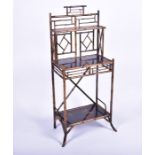 A Victorian Aesthetic Movement bamboo and lacquer stand the top with a small shelf over a larger