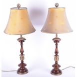 A pair of brass and turned wood table lamps with shades, 80 cm high.