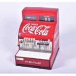 A mid-20th century Coca Cola branded cash register bearing a label for 'The National Cash Register