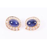 Van Cleef and Arpels. A pair of 18ct yellow gold, diamond, and sapphire earrings each centred with