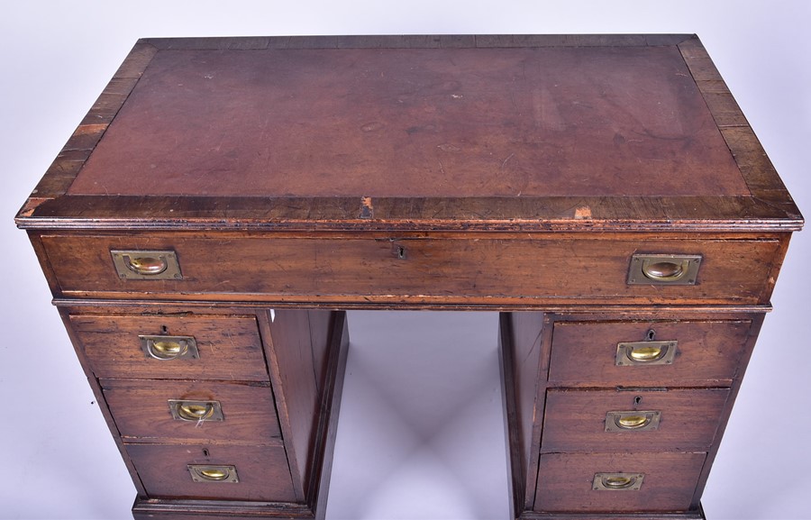 An Edwardian oak nine drawer pedestal desk with brass campaign handles, 101 cm x 79 cm x 54 cm. - Image 7 of 9