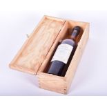 A bottle of 1954 Baron de Lustrac Armagnac Appellation Armagnac Controlee, 40% Vol, in a wooden