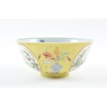 A Chinese Guangxu Famille rose bowl decorated with polychrome enamels, the yellow ground with