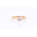An 18ct yellow gold and solitaire diamond ring set with a round brilliant-cut stone of approximately