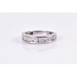 A 9ct white gold and diamond half eternity ring channel-set with thirteen round-brilliant cut