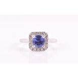 An 18ct white gold, diamond, and tanzanite cluster ring set with a round-cut tanzanite,