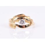 An unusual 18ct yellow gold and diamond ring in the form of a stylised eye, centred with a round