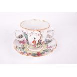 A 18th century Chinese two-handled tea cup and underplate decorated with panelled scholar and garden