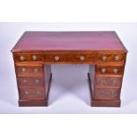 A Victorian figured walnut small pedestal desk the inset red leather top over three frieze drawers