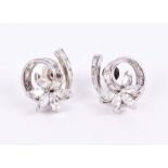 A pair of diamond floral cluster earrings each set with a spray of five marquise-cut diamonds, on