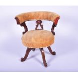 A Victorian button-back upholstered swivel chair with scroll decoration, on four swept feet, 71 cm