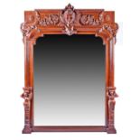 A large Rococo style carved hardwood wall mirror with ornately carved frieze decorated with