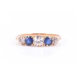 An 18ct yellow gold, diamond, and sapphire ring set with three old-cut diamonds of approximately 0.