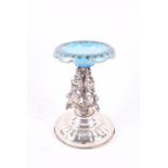 A 19th century continental silver salt cellar with pale blue glass bowl, raised on three scrolled