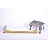 A 19th century cast iron footman / trivet supported on paw feet, 54 cm wide, together with a