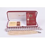 A simulated pearl necklace together with another double strand faux pearl necklace with silver and
