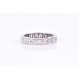 A white gold and diamond eternity ring set with baguette-cut and round brilliant cut stones of