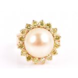 An 18ct yellow gold, fancy yellow diamond, and pearl cocktail ring set with a golden pearl, possibly
