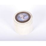 A 19th century ivory cylindrical box inset with a portrait miniature of a lady, 3.5 cm x 4.3 cm